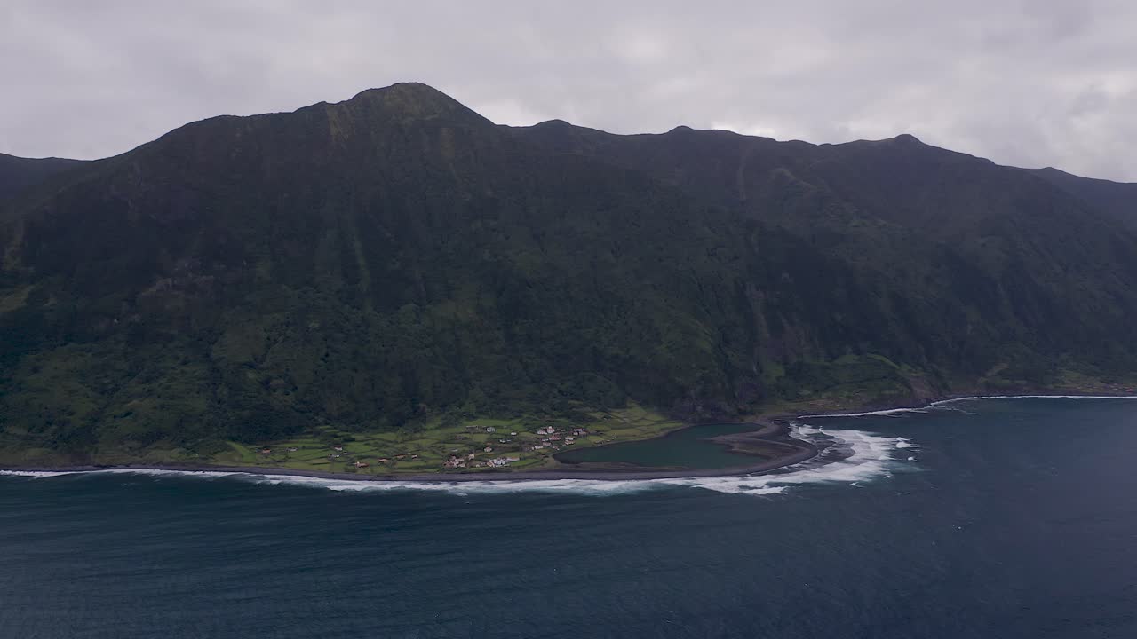 coastal rural village, a lagoon, with lush green cliffs landscape, FajÃ£ de Santo Cristo, SÃ£o Jorge island, the Azores, Portugal