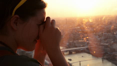 tourist taking photograph of sunset in london skyline  view from the shard