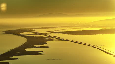 sete from the distance aerial golden hour yellow sea and ponds