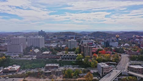 Aerial-View-of-Downtown-Knoxville,-TN-in-the-Fall-with-Mountains-in-Background