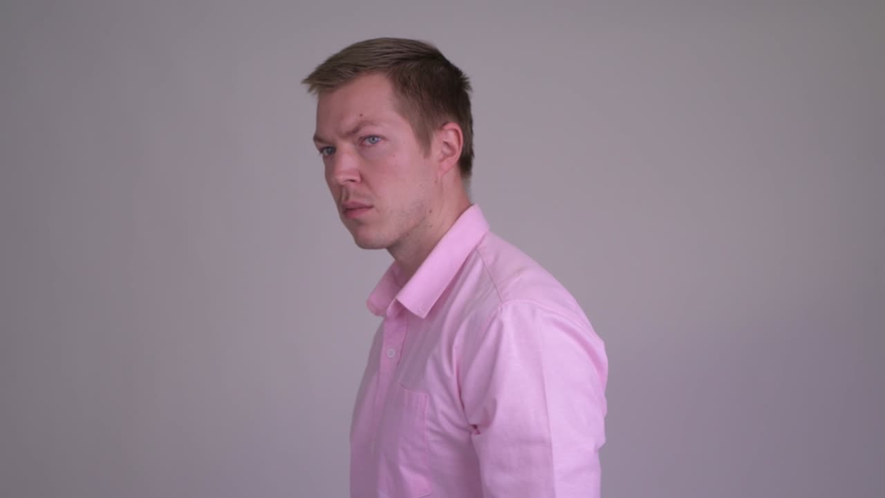 Young handsome businessman with pink shirt