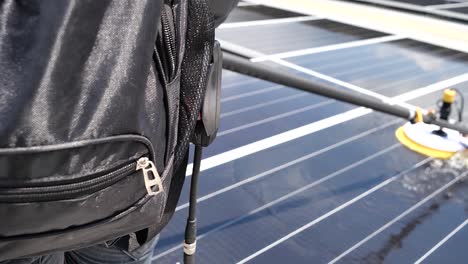 worker use machine to wash solar cell panel, daylight