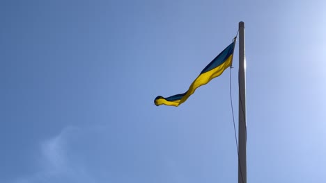 swedish flag waving on pole on sunny summer day.