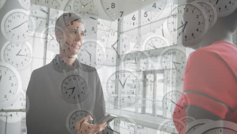 Animation-of-moving-clocks-over-diverse-colleagues-discussing-work-in-office