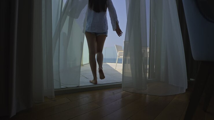 Woman on a balcony with ocean view