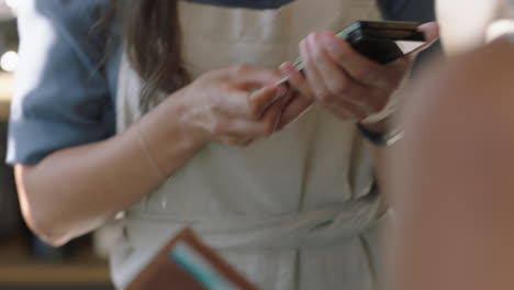 business woman making payment using credit card in coffee shop friendly cashier serving customer spending money on wireless transaction service close up