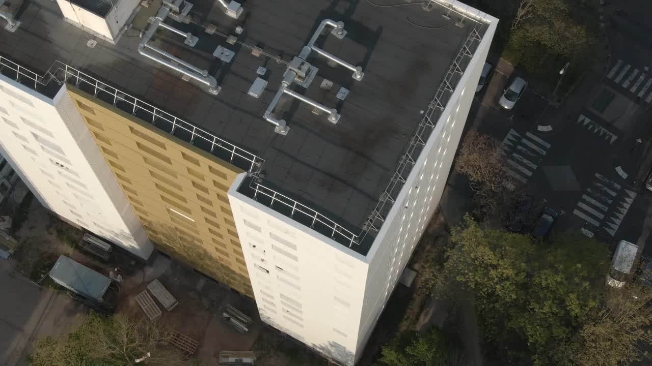 Top-down drone perspective of an apartment building rooftop in Nantes. Urban planning, residential architecture detail. France