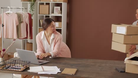 woman and woman working in their business, organize cardboxes to delivery