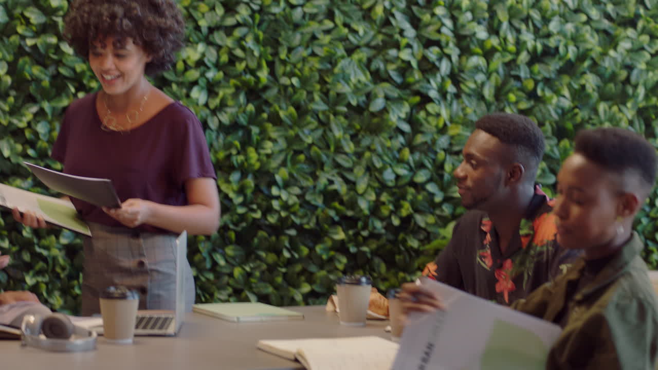african american business people meeting team leader woman sharing corporate documents colleagues working together on creative project brainstorming ideas in office presentation