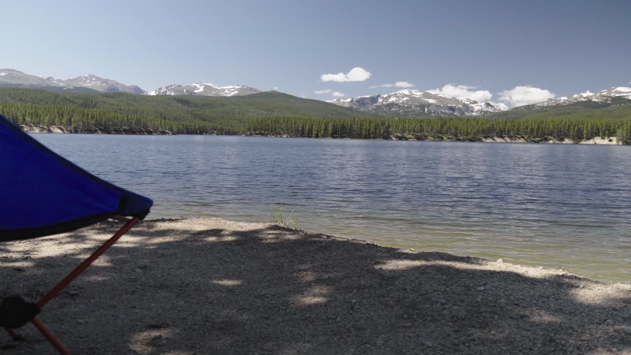 vista de camión de una silla de camping parada en la orilla del embalse del parque en verano con nubes descansando desierto en el fondo en el bosque nacional bighorn en wyoming
