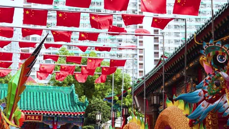 colorful temple with chinese flags in hong kong