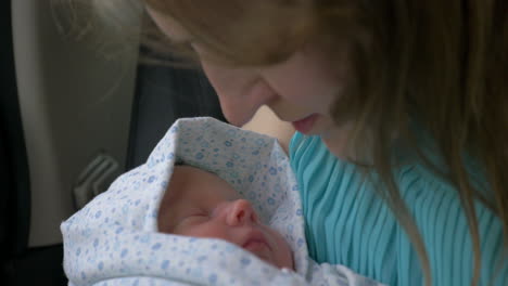 new born baby sleeping in mothers hands