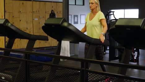 woman doing exercise on treadmill in fitness studio 4k