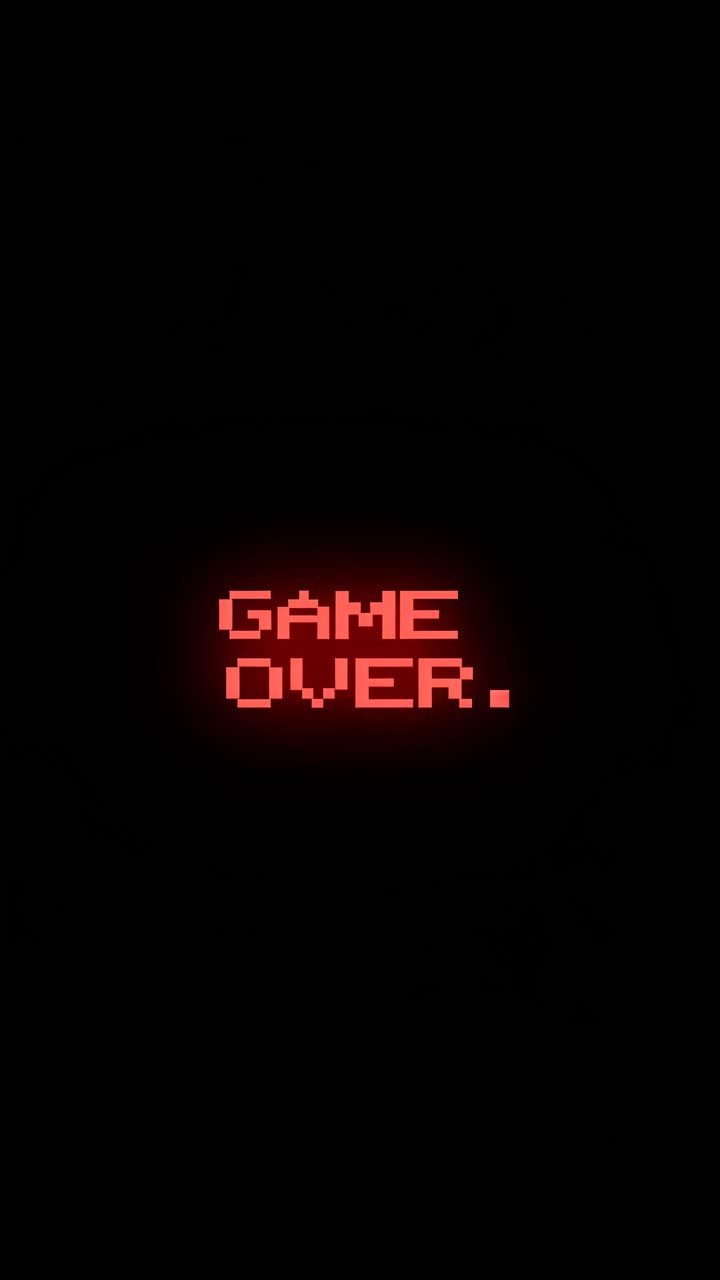 Retro video game over screen with glowing red pixelated text on a black background