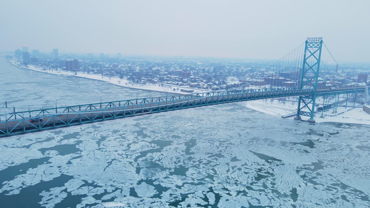 Ambassador Bridge crossing frozen Detroit river between Detroit and Windsor