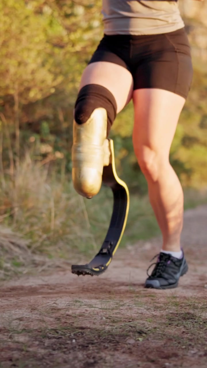 Female Athlete with Prosthetic Running Blade Jogging on Trail