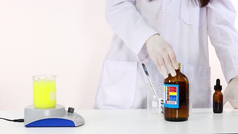 scientist performing iodine clock chemical reaction experiment in laboratory setting