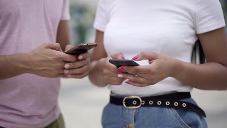 cropped shot of young people using smartphones