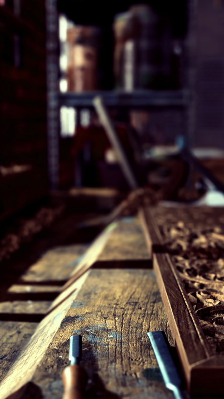 Woodworking project in workshop with ornate carvings and tools at workbench