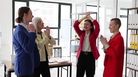 business colleagues celebrating success and cheering in office