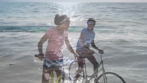 animation of happy african american couple with bikes over seascape