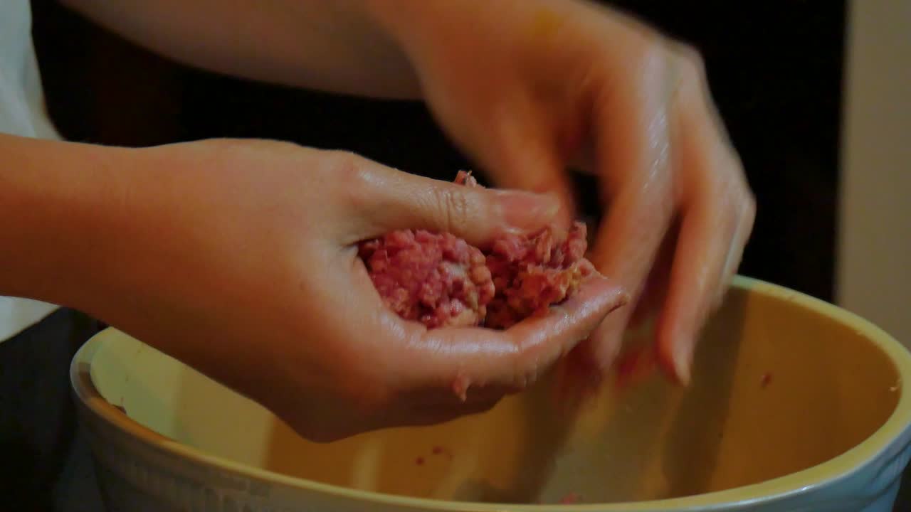 Creating meatballs in a kitchen