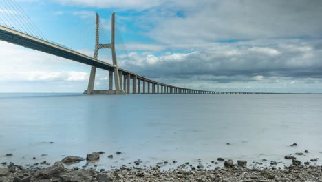 Timelapse-of-the-Vasco-da-Gama-bridge-in-Lisbon,-Portugal-on-a-cloudy-day