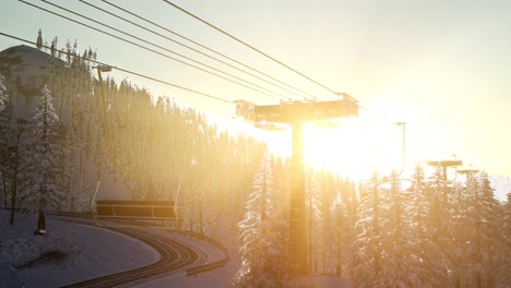 empty ski lift. chairlift silhouette on high mountain over the forest at sunset