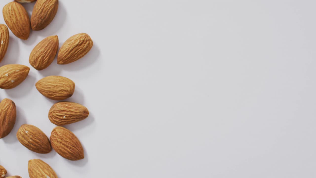 Video of almonds on white background