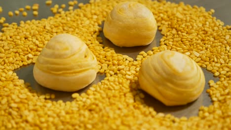 yellow chinese pastry and peel mung bean on table, close up-1