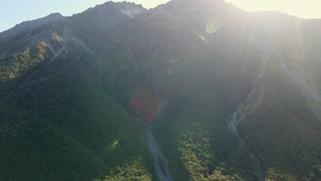 Avalanche-and-meltwater-river-tracks-on-side-of-steep-mountain-at-sunrise