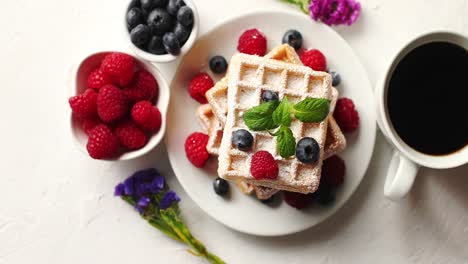 coffee and berries near waffles