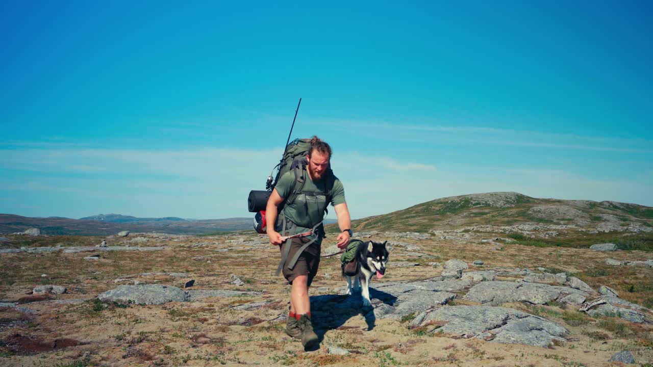 Male Hiker And His Dog Walking In Hiking Trail In Indre Fosen, Norway - Wide Shot