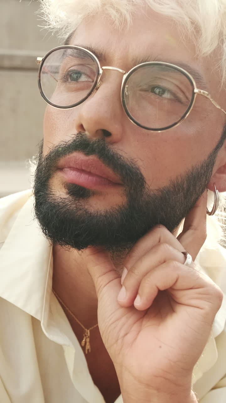 Thoughtful Man with Beard and Glasses Looking Up