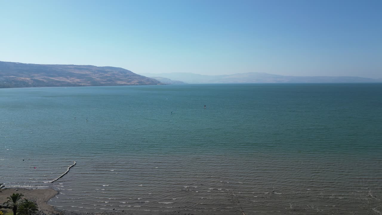 Peaceful scenic view of the Sea of Galilee in Israel. Calm blue waters, distant hills, and natural light create a serene and timeless Middle Eastern landscape
