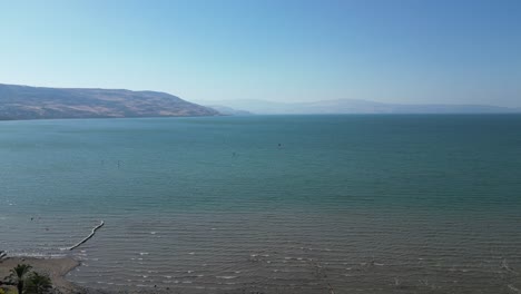 peaceful scenic view of the sea of galilee in israel. calm blue waters, distant hills, and natural light create a serene and timeless middle eastern landscape