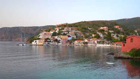 Vista-Del-Paisaje-Marino,-Pintoresco-Pueblo-Colorido-De-Assos-Junto-Al-Mar-Durante-La-Puesta-De-Sol,-Isla-De-Kefalonia