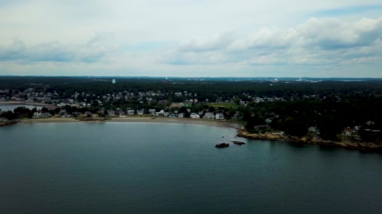 Aerial forward view of a village by the sea. Swamscott beach