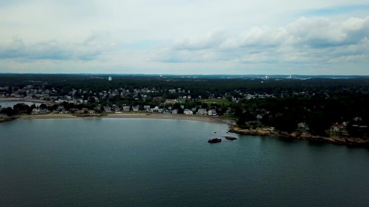 Aerial forward view of a village by the sea. Swamscott beach