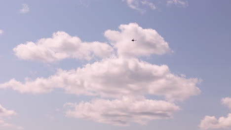 Helicopter in the Sky with Fluffy Clouds