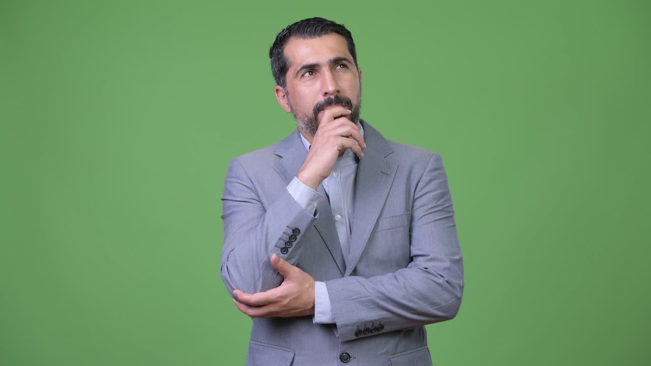 Handsome Persian bearded businessman thinking