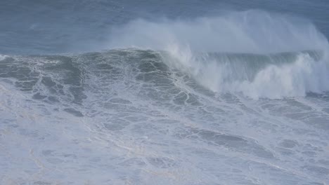 enormous waves crashing on the coast of nazare, portugal, showcasing the raw power of the ocean