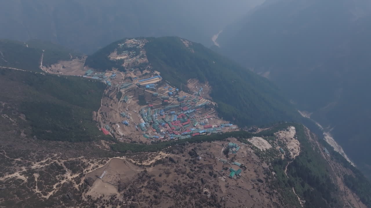 Drone shot of Namche Bazaar and Himalayan highlands, showing rivers, trails, greenery, housing, and lifestyle in Sagarmatha National Park tourism and scenery exploration