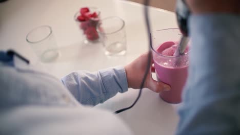 woman's hands slicing strawberries cooking, cutting fruits in half