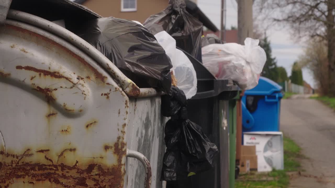 Overflowing garbage bins on a rural road