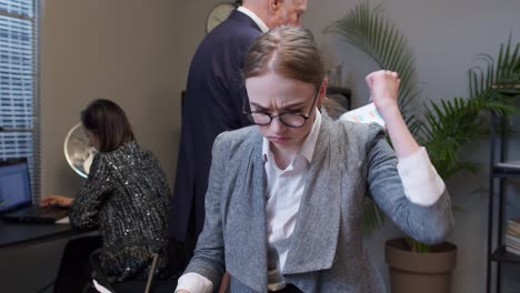 young unhappy secretary girl irritated sad angry mad after analyzing financial papers in office