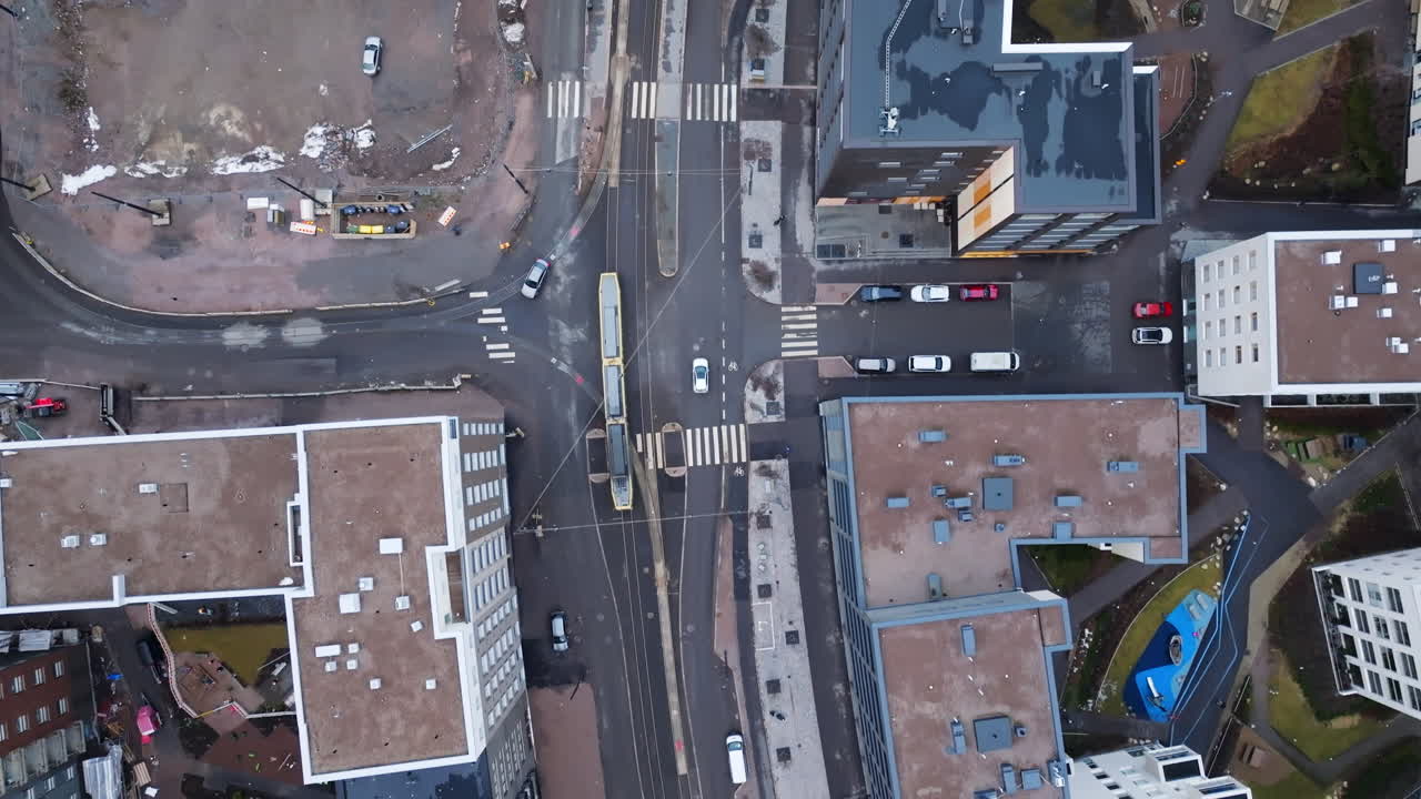 Birds eye drone shot following a tram on the streets of Helsinki, spring day