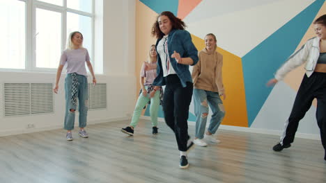 group of young women dancing in a studio