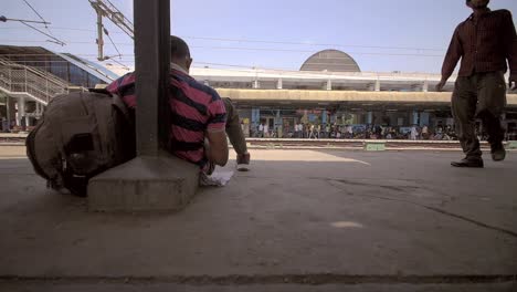 man sitting on train platform