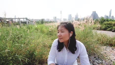 an asian woman in public park.